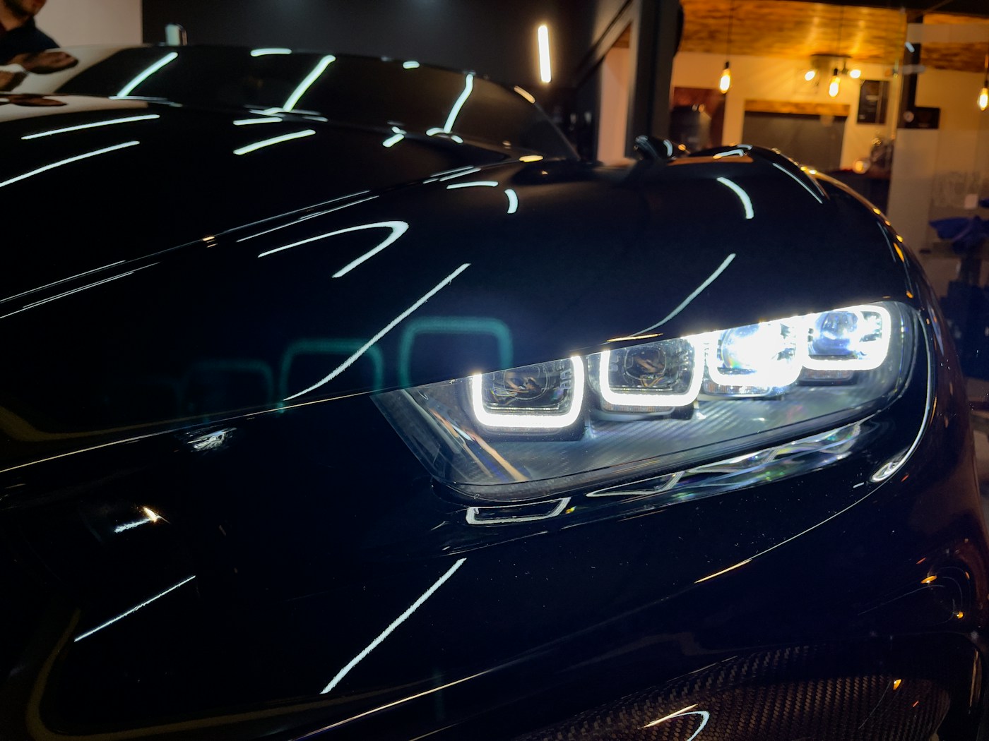 Close-up of a polished black car and headlight — stock automotive photograph